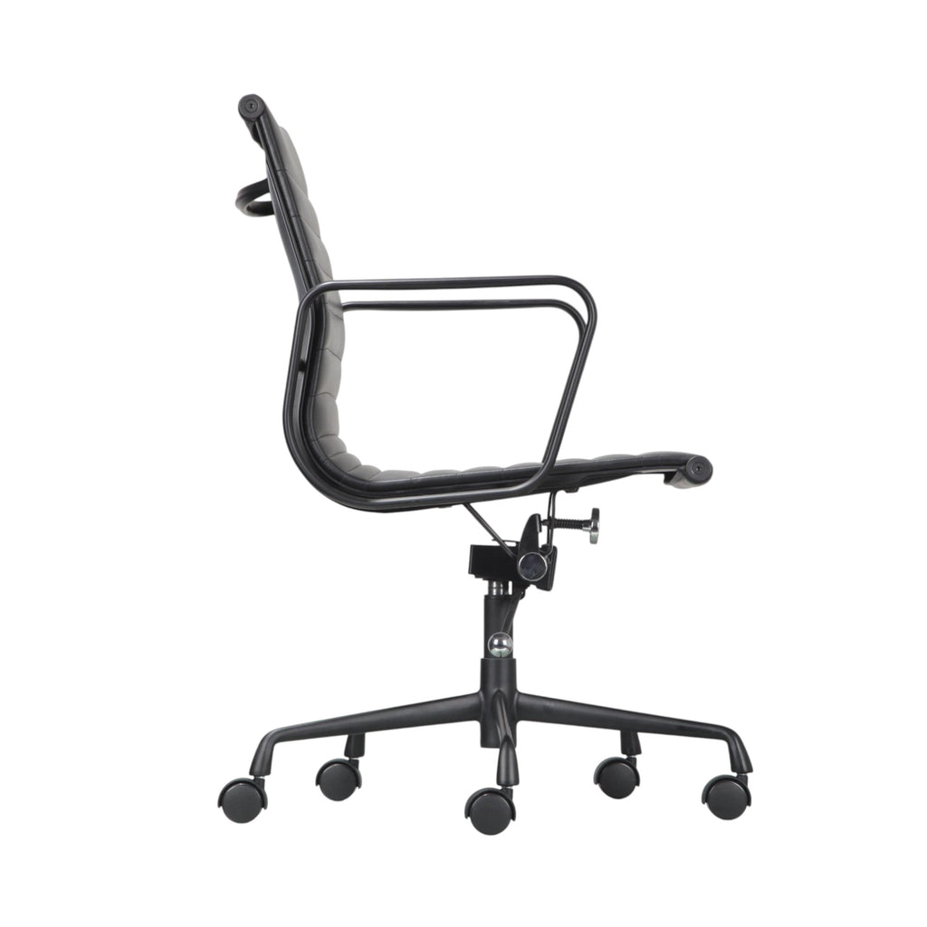Xiaoyaozuo office chair black faux leather executive chair with armrests and horizontal stitching on a metal base with casters.