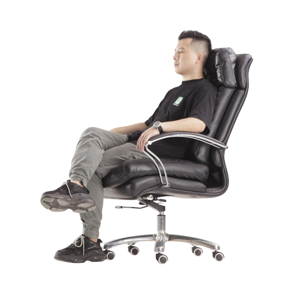 Xiaoyaozuo office chair: Black faux leather executive chair with plush cushioning, high backrest, and ergonomic design. Man sitting.