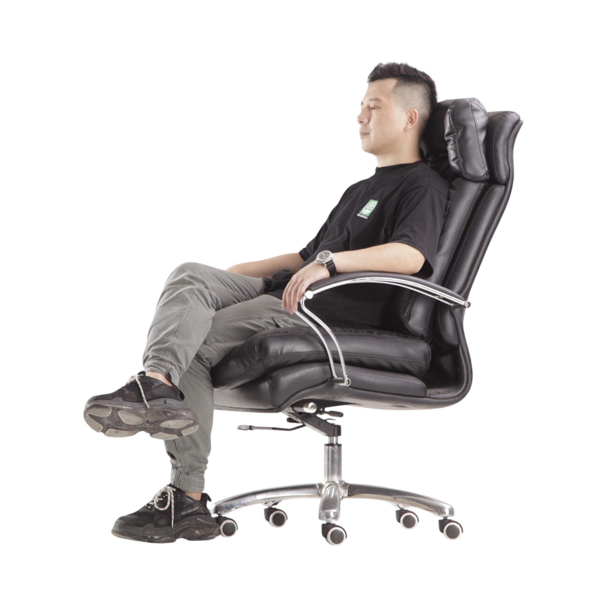 Xiaoyaozuo office chair: Black faux leather executive chair with plush cushioning, high backrest, and ergonomic design. Man sitting.