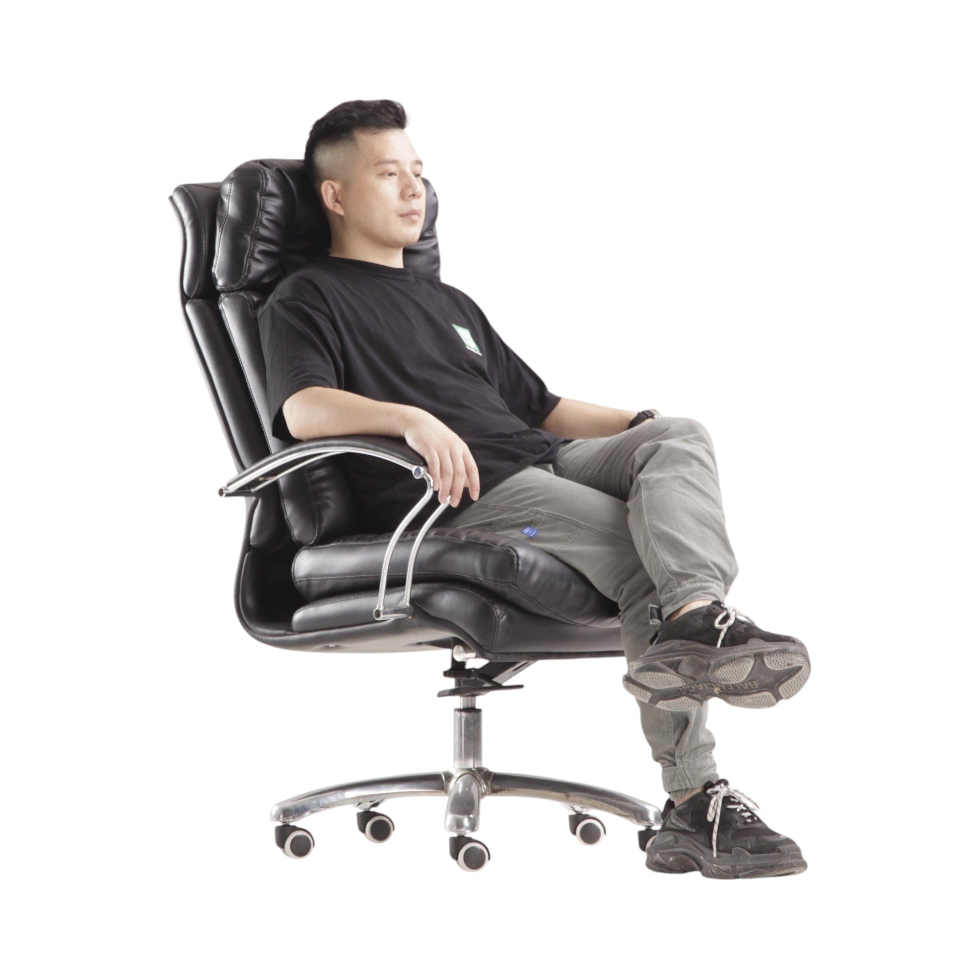 Xiaoyaozuo office chair: Black executive faux leather chair with plush cushioning, high backrest, and chrome accents. Man sitting.