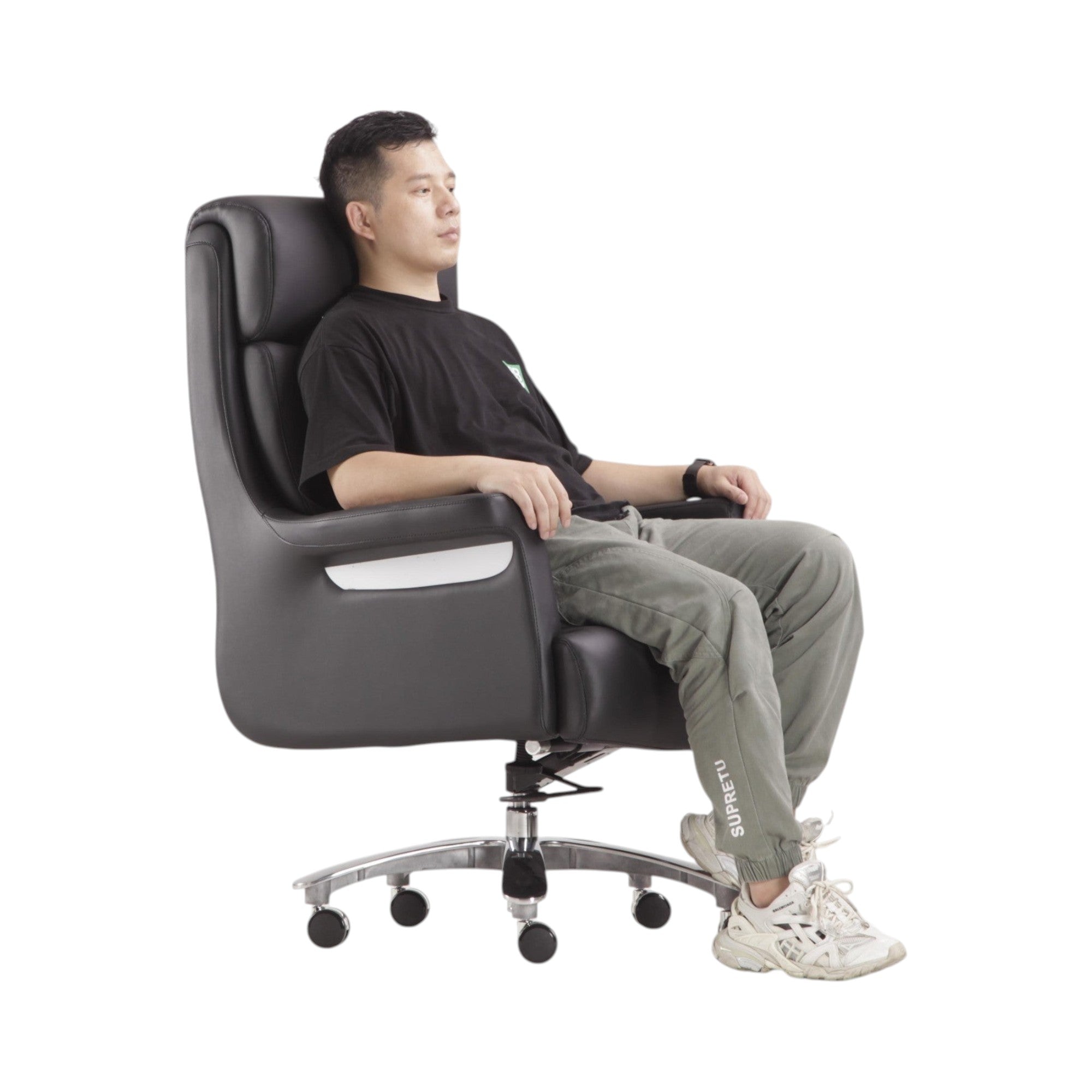 Xiaoyaozuo office chair: Black faux leather executive high back office chair with chrome accents and casters. Man sitting.