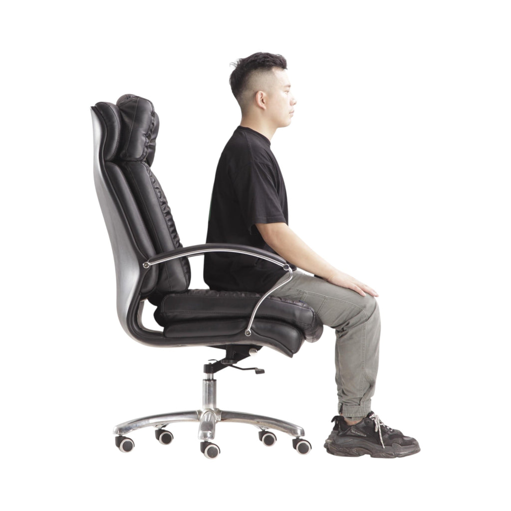 Xiaoyaozuo office chair: Black faux leather executive chair with plush cushioning, high backrest, and adjustable height. Model seated.