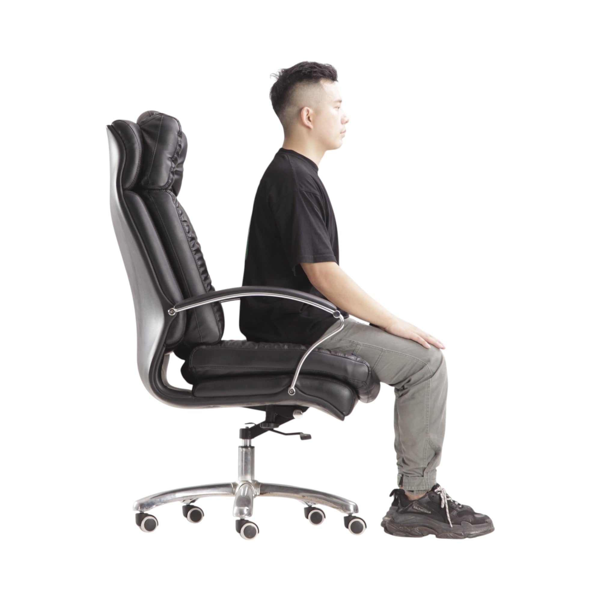 Xiaoyaozuo office chair: Black faux leather executive chair with plush cushioning, high backrest, and adjustable height. Model seated.