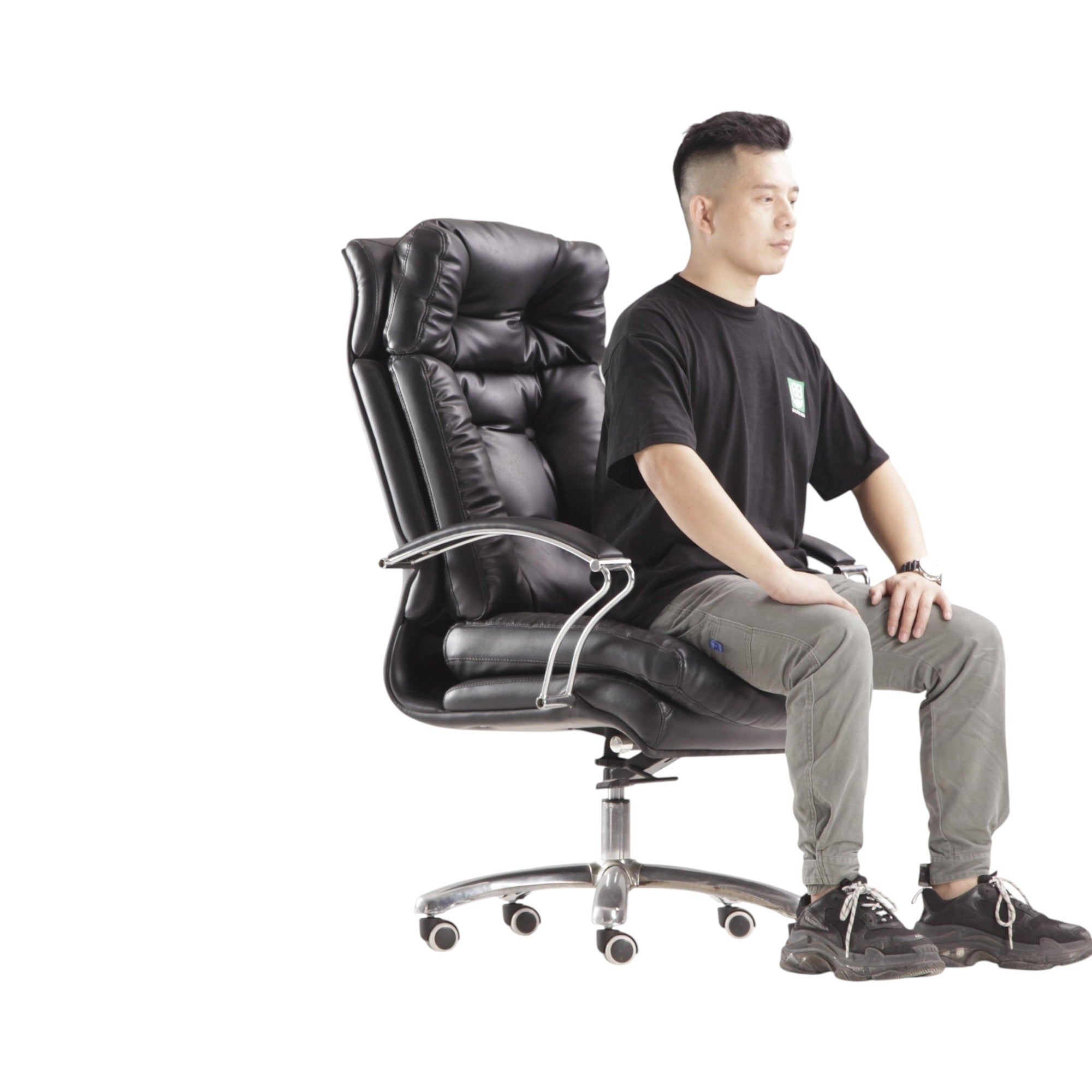 Xiaoyaozuo office chair: Executive black faux leather padded office chair with high backrest and chrome casters. Man sitting.