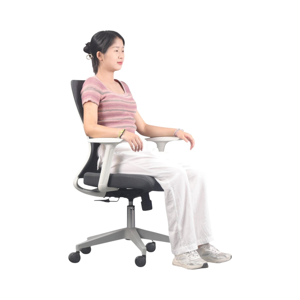 Xiaoyaozuo office chair: Woman sitting in a black and white ergonomic mesh office chair with adjustable height and casters. Breathable mesh back and padded seat for comfort.