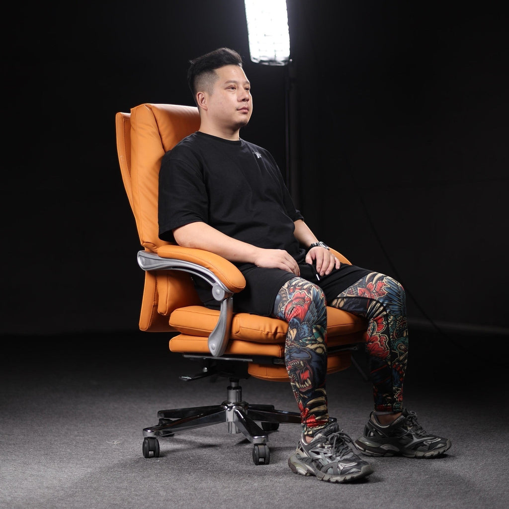 Xiaoyaozuo office chair executive PU leather chair in orange with integrated footrest and high backrest.
