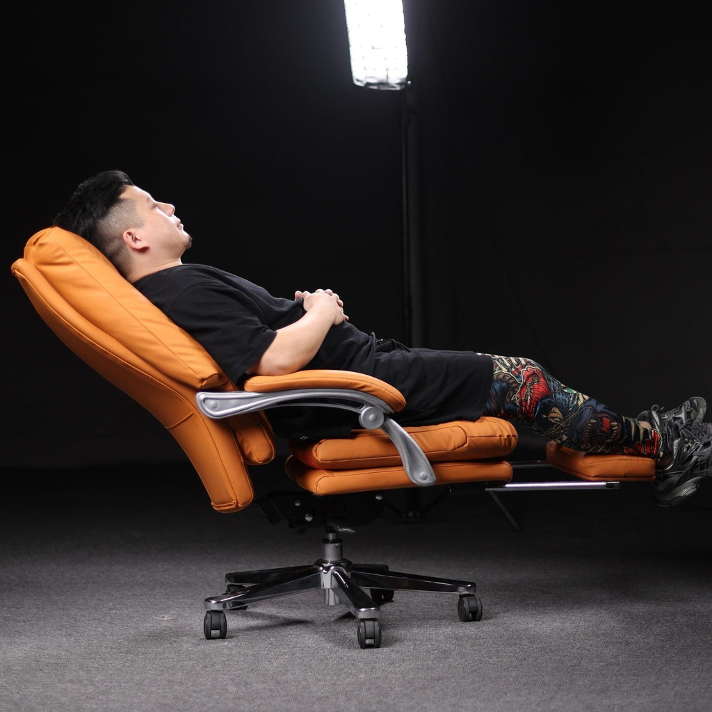 Xiaoyaozuo office chair executive PU leather chair in orange with reclined footrest and high backrest, man relaxing.