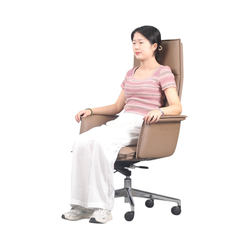 Xiaoyaozuo office chair executive high-back chair in tan faux leather with polished chrome base and casters, shown with a woman seated.