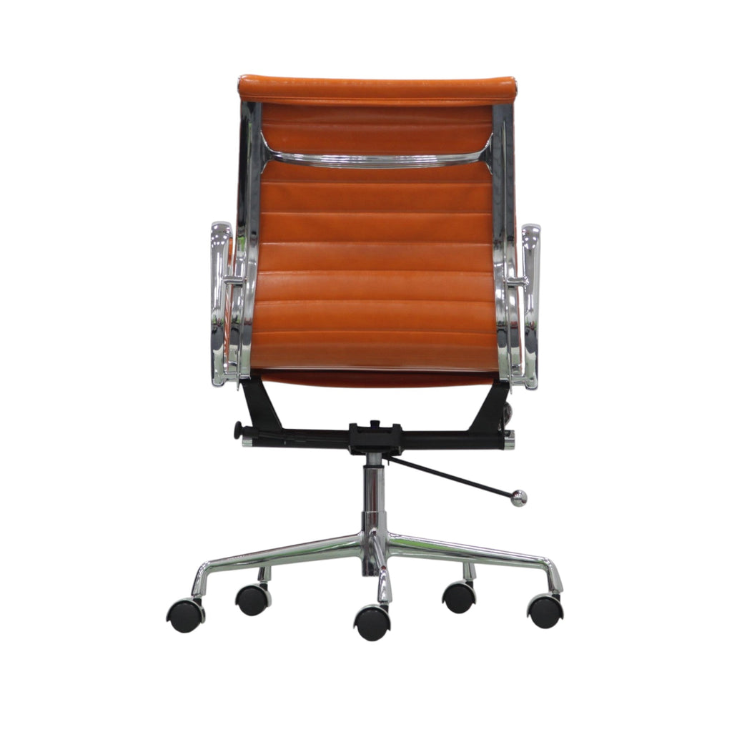 Xiaoyaozuo office chair, orange faux leather executive chair with chrome armrests and base, ribbed backrest, on casters.